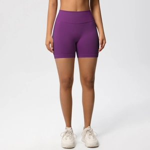 Close-up of seamless purple high-waisted fitness shorts with wide tummy control waistband