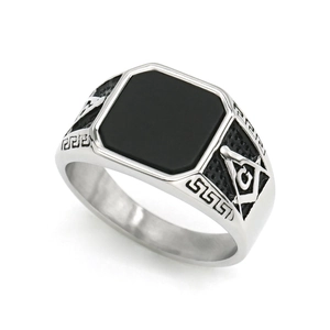 Vintage silver mens Freemasonry ring with square black stone on a white background