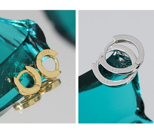 Detailed view of S925 sterling silver hoop earrings in gold and silver mirror finish