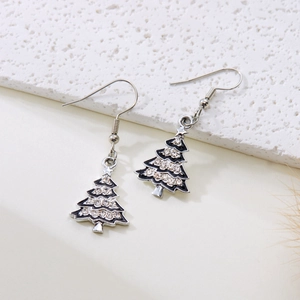 Detailed view of silver Christmas tree earrings with sparkling rhinestones and black enamel
