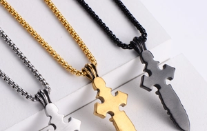 Macro detail of gothic skull cross pendants in gold, silver, and black plating finishes