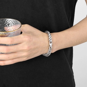 Silver stainless steel dragon bone link bracelet on wrist with jewelry clasp