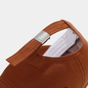 Close-up of the adjustable metal buckle and twill cotton strap on the baseball cap
