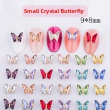 Close-up of small 9x8mm colorful crystal butterfly nail charms in various vibrant shades