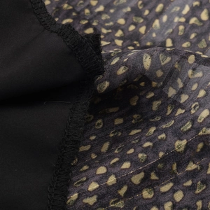 Bohemian loose dress in black fabric with gold leopard polka dots and stitching details