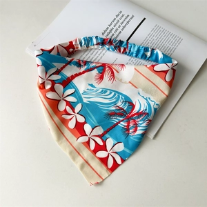 Detail of tropical palm tree print on triangular hair bandana with elastic band