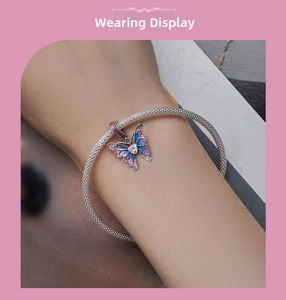 Detail of s925 silver woven bracelet with a pink gradient enamel butterfly charm