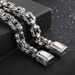 Macro detail of silver skull link bracelet made of polished stainless steel with clasp
