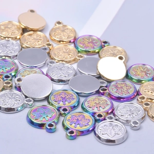 Macro shot of stainless steel snowflake pendants in gold, silver and rainbow finishes
