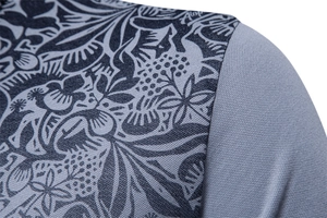Close-up of khaki polo shirt featuring intricate blue floral print and breathable mesh fabric