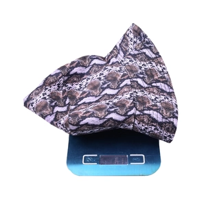 Detailed view of snake skin bucket hat weighing 61g on a scale showing lightweight material