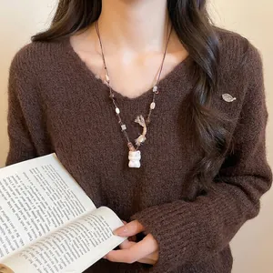 Maillard retro acrylic cat pendant necklace with stars and tassels on brown sweater
