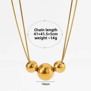 Detailed view of triple gold bead pendant necklace with 14mm central sphere and snake chain