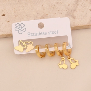 Detailed macro view of gold-plated stainless steel butterfly earrings and hoop set