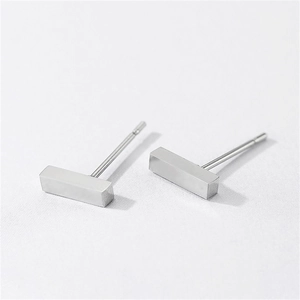 Macro shot of minimalist silver stainless steel rectangular geometric stud earrings