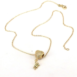 Golden necklace featuring a 3D bear pendant and a heart bead with white zircon inlay