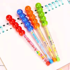 Detail of multi-color stacking smiley face pencils on white spiral notebook