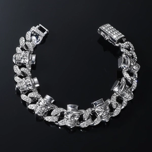 Silver punk skull Cuban link bracelet with sparkling rhinestones on black background