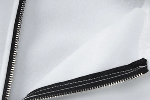 Macro detail of soft fleece lining and high-quality black zipper on white hooded jacket