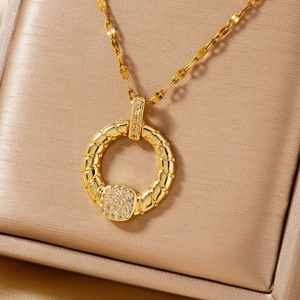 Elegant gold pendant necklace with spiral texture and sparkling cubic zirconia on satin