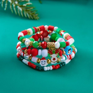 Detail of 4-piece Christmas beaded bracelet set with Santa Claus and snowflake charms