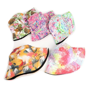 Five reversible floral print bucket hats for women featuring tropical palm tree designs