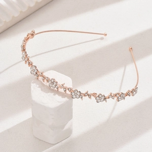Detail of rose gold flower headband with sparkling rhinestones and crystal vine design