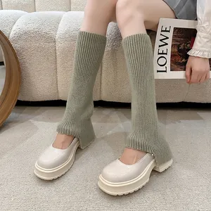 Y2K grey-green knit leg warmers styled with platform shoes in a cozy home setting