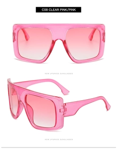 Detail view of pink gradient lenses and transparent pink frames on oversized sunglasses