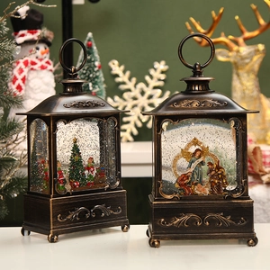Bronze Christmas snow globe lantern featuring Nativity and tree scenes with swirling glitter