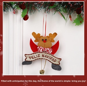 Detail of plush Christmas reindeer ornament with Merry Christmas tag and golden bell