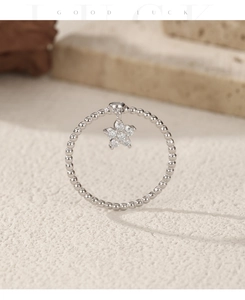 Detail of S925 sterling silver beaded ring featuring a sparkling star pendant with zircons