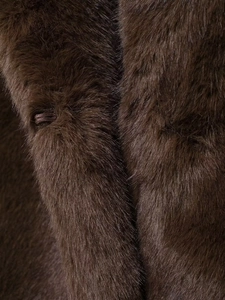 Close-up of deep brown faux fur texture showing soft fibers and luxury material finish