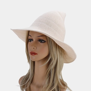 Detail of knit beige witch hat showing fine crochet texture and wide wavy brim