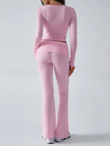 Rear view of pink slim-fit knit long sleeve top and flared trousers two-piece set