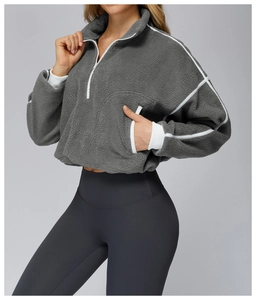 Detail view of grey fleece jacket featuring white zipper and contrast trim design