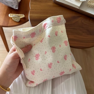 Close-up of floral drawstring cotton pouch showing small pink flower patterns