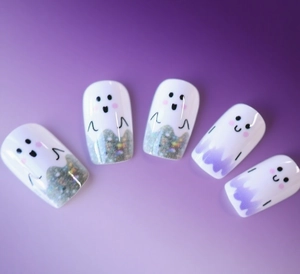 Detailed view of Halloween ghost press-on nails with purple gradients and silver glitter