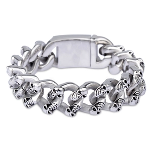 Macro detail of silver skull link bracelet in punk style with polished metal finish