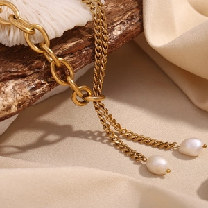 Detail of 18K gold plated double layer Cuban chain necklace with fresh water pearls