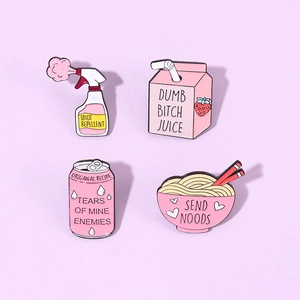 Detail view of four pink enamel pins including strawberry juice and ramen noodle designs
