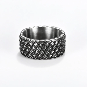 Vintage stainless steel wide band ring with intricate woven texture on white background