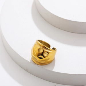 Macro detail of 18K gold stainless steel ring with unique hammered texture and open band