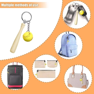 Detailed view of mini wooden baseball bat and yellow softball pendant on key ring