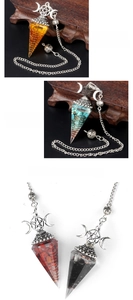 Macro detail of hexagonal crystal pendulums with silver moon and star metal symbols