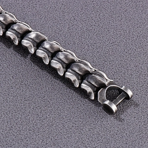 Macro detail of antique silver dragon bone link bracelet in punk style titanium steel