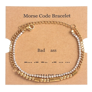 Detail of gold Morse code double-layer bracelet with crystal rhinestones on display card