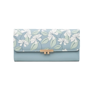 Close-up of floral pattern flap and golden metal double ball clasp on a blue wallet