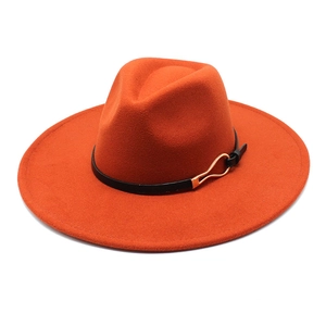Detail of orange fedora wool hat featuring a black leather band and gold metal buckle