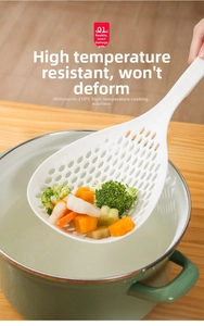 Deep skimmer spoon straining broccoli and shrimp from a green pot in the kitchen